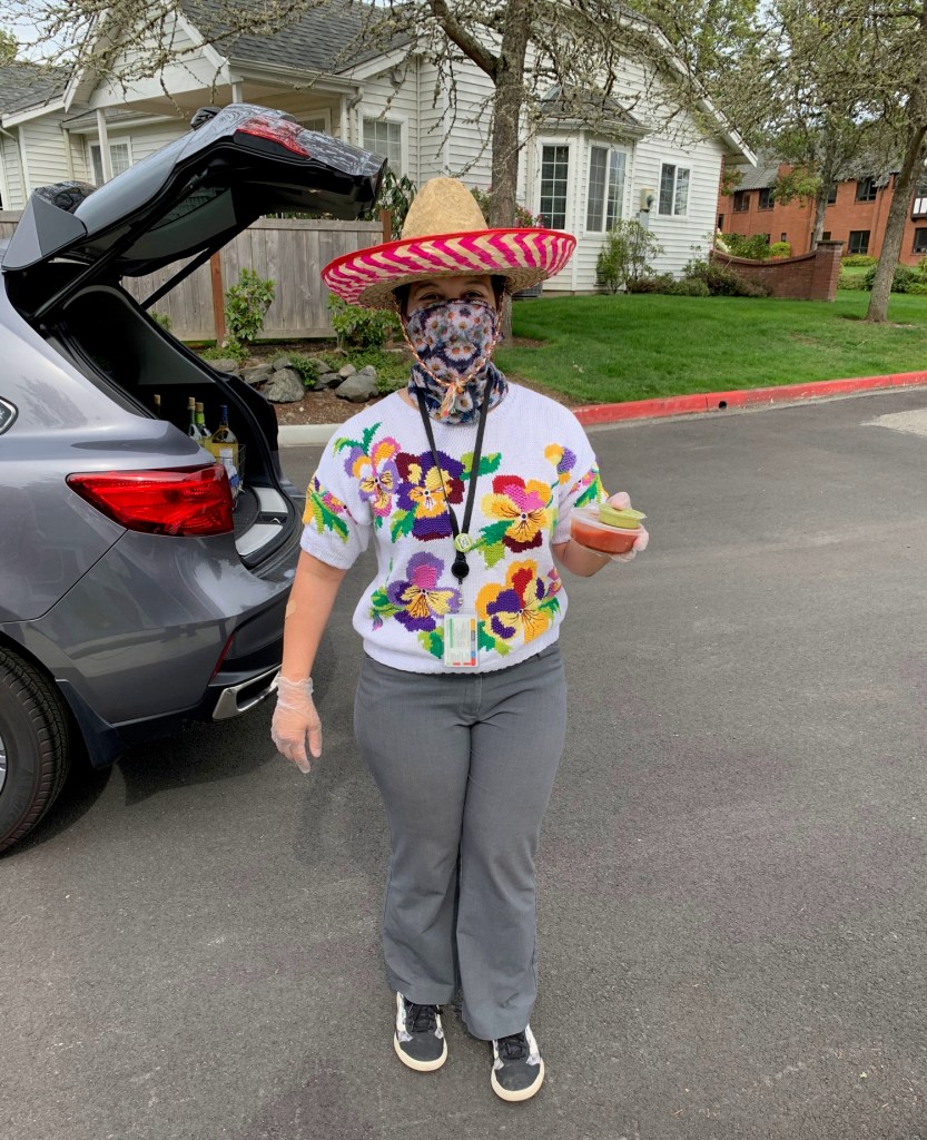 woman wearing sombrero and carry chips, guacamole, and salsa